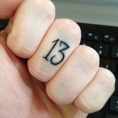 someone has written the number thirteen on their finger