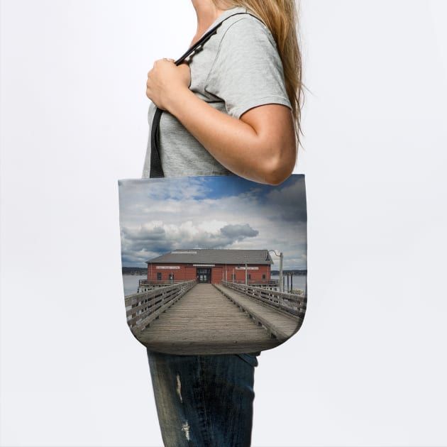 a woman carrying a tote bag with an image of a building