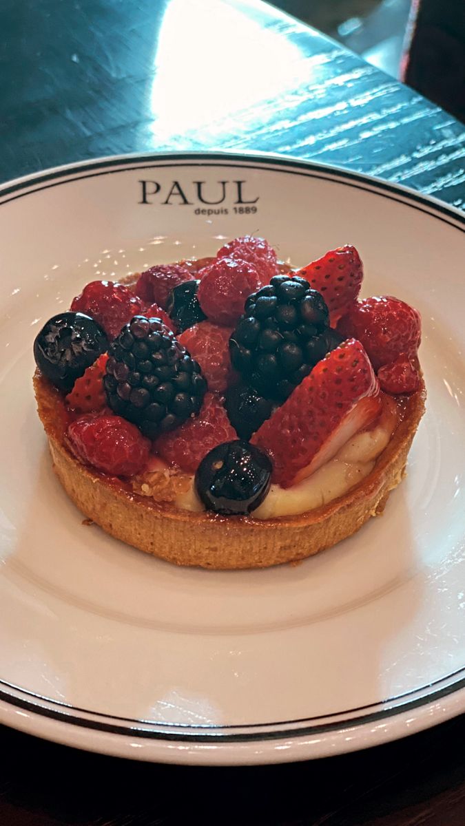 a pastry topped with berries on top of a white plate