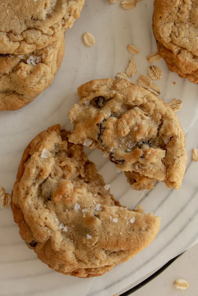 several cookies on a plate with one broken in half