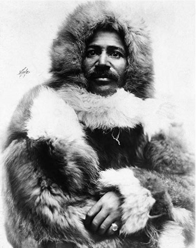 an old black and white photo of a man wearing a fur coat