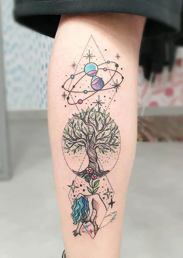 a woman's leg with tattoos on it and an image of a tree in the middle