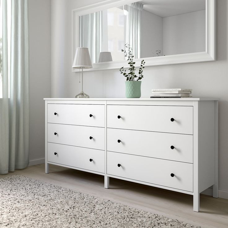 a white dresser and mirror in a room