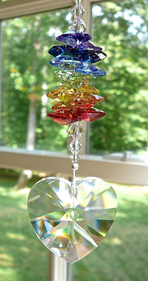 a wind chime hanging in front of a window filled with lots of different colored glass pieces