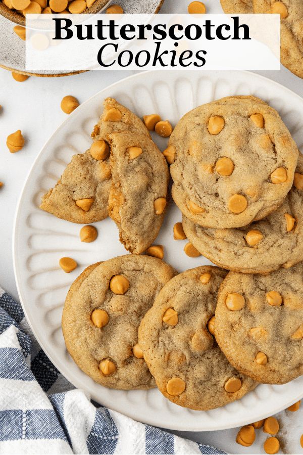 chocolate chip cookies on a white plate with butterscotch chips in the background and text overlay that reads, butterscotch cookies