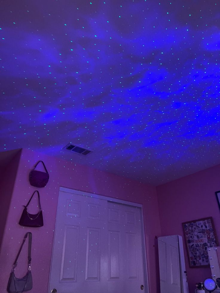 the ceiling is decorated with stars and lights in purple tones, as well as pink walls