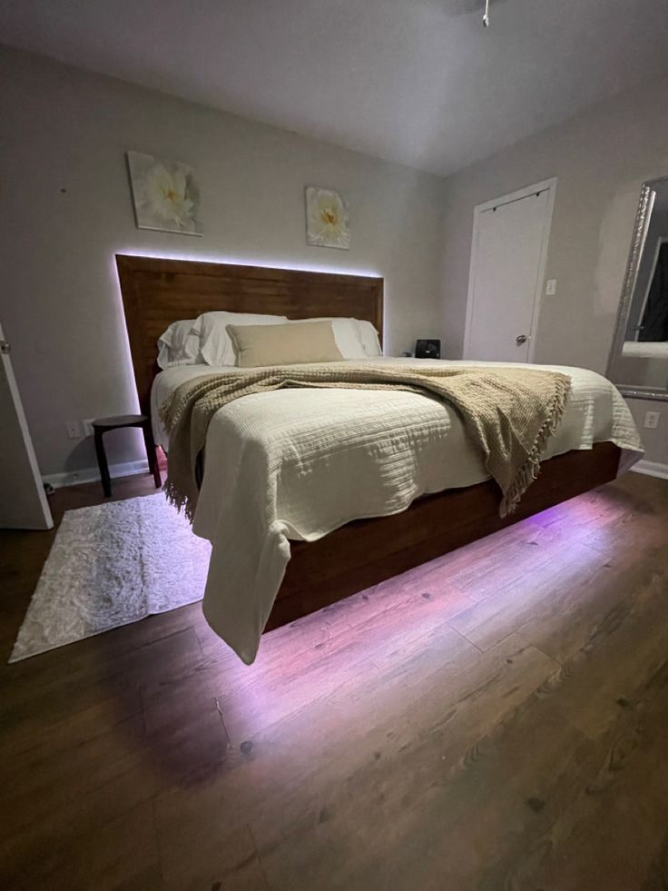 a large bed sitting on top of a hard wood floor