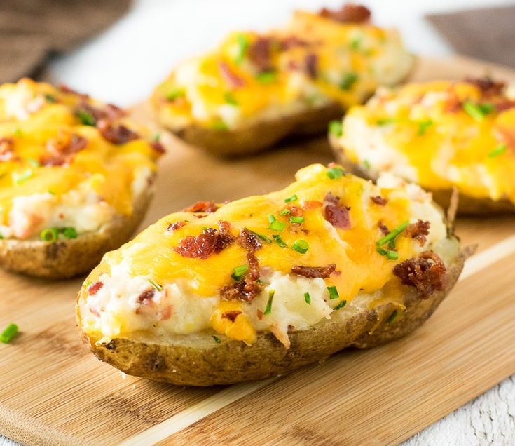 baked potato skins with cheese and bacon on a cutting board, ready to be eaten