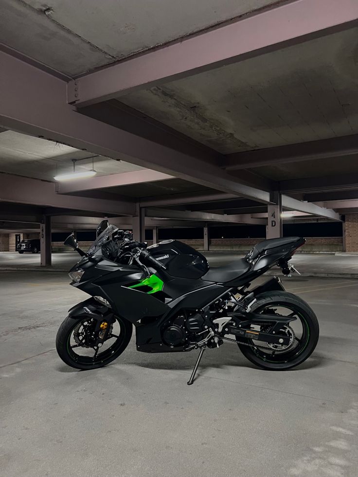 a black motorcycle parked in a parking garage