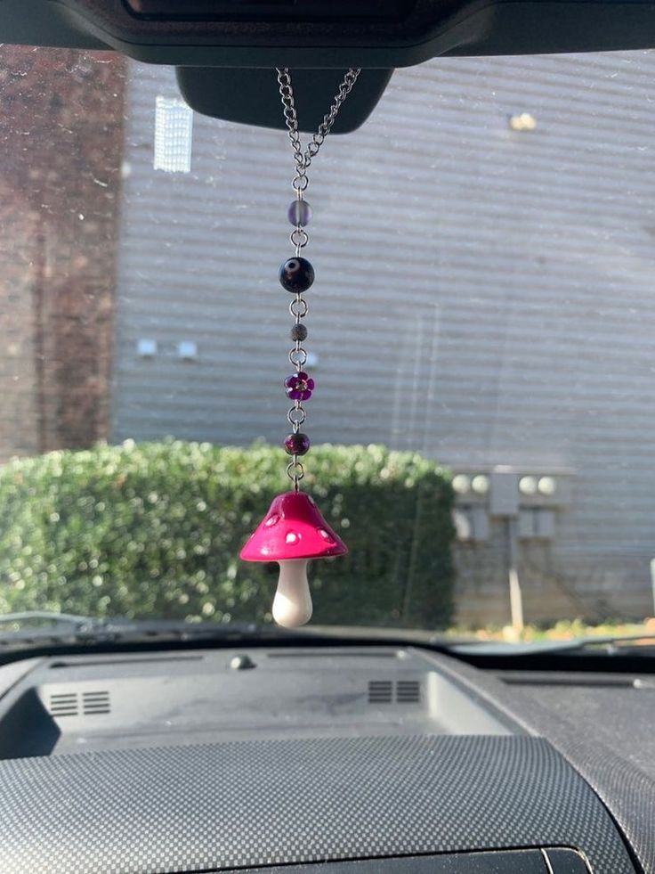 a car dashboard with a pink and white lamp hanging from it's dash board