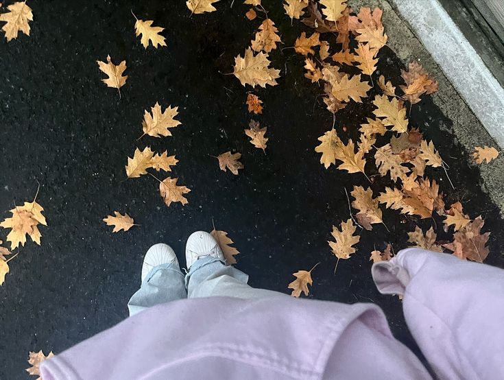 a person standing in front of leaves on the ground