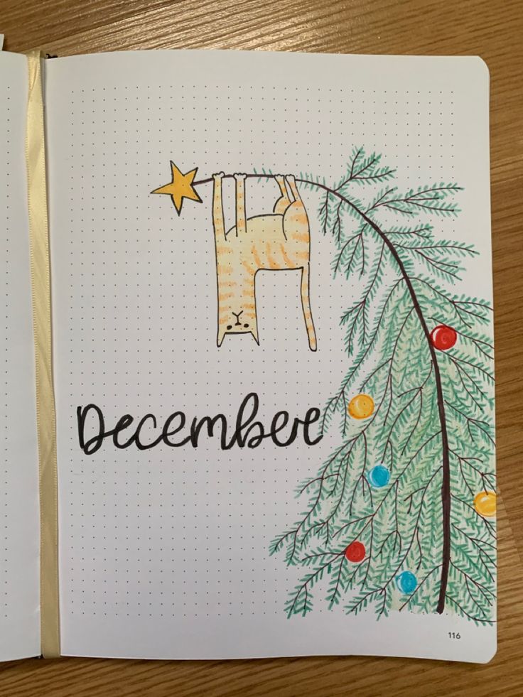 a notebook with the word december written on it and a drawing of a horse hanging from a christmas tree