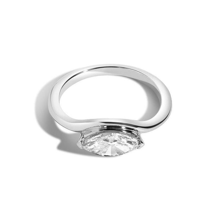 We uphold our brand promise of honoring personal journeys by inviting our customers to celebrate one of life’s biggest milestones - our deco bridal capsule draws inspiration from the decadence of the roaring 20’s, made anew by fashioning the deco silhouettes into minimal designs better fit for 2020. A marquise diamond becomes the eye of this curved band, designed as a decorative symbol to protect love. Marquise is v-prong set and pairs well with the baguette curved band. Metal: 14K Yellow Gold, Modern Classic Cut Wedding Jewelry, Classic Cut Fine Jewelry Diamond Ring, Luxury Rose Gold Ring With Tension Setting, Luxury Marquise Cut Wedding Jewelry, Luxury Marquise Cut Wedding Ring, Modern Marquise Cut Diamond Ring, Luxury Jewelry With Tension Setting For Wedding, Marquise Tension Setting Formal Jewelry, Marquise Tension Setting Fine Jewelry