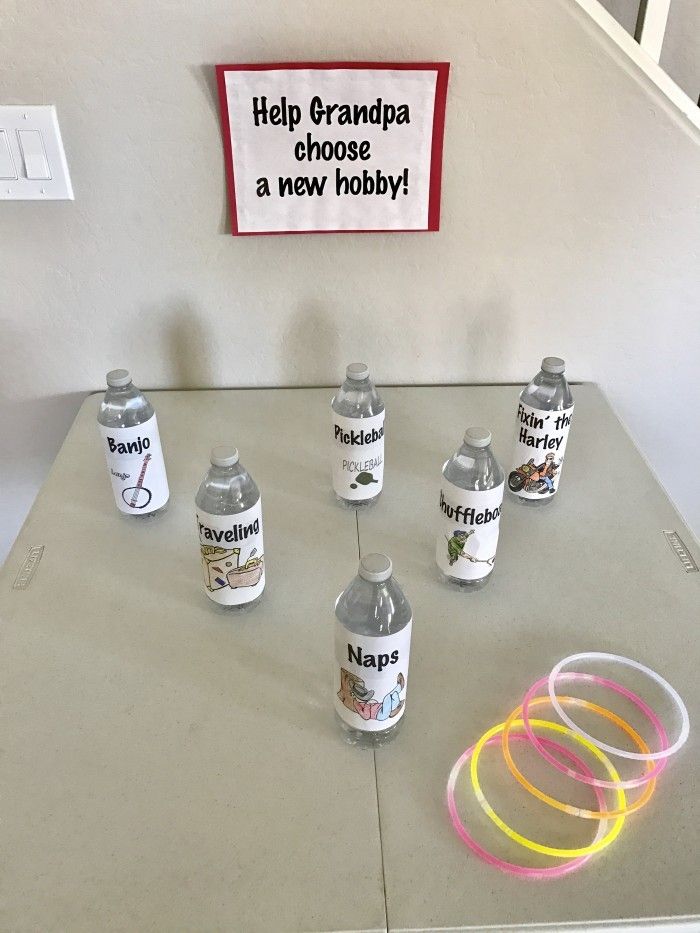 there are many bottles on the table with neon bands around them and a sign that says help grandpa choose a new hobby