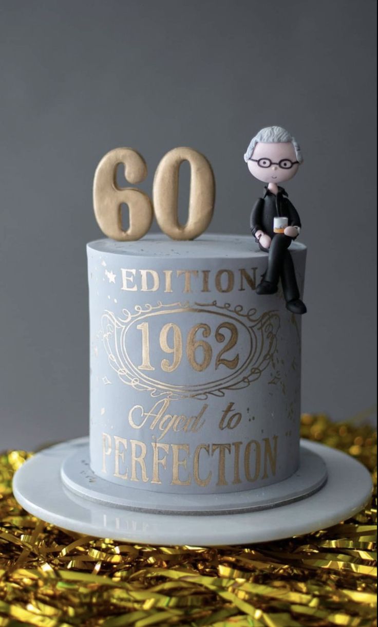 a 50th birthday cake with a figurine on top