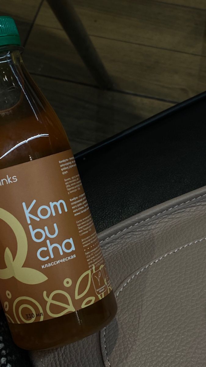 a bottle of kombu cha is sitting on the seat belt