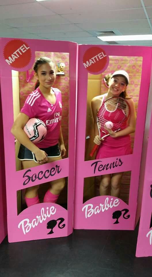 three pink barbie dolls are standing next to each other in front of a sign that says soccer, tennis and barbie