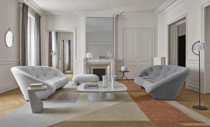 a living room with two chairs and a coffee table in the middle of the room