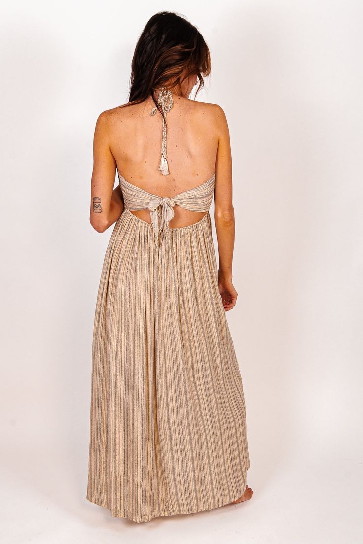 Vacay approved is our From The Source Pocketed Halter Maxi Dress is perfect for any event this season. We love the flowy, lightweight striped fabrication for a classy and flattering fit. Designed with maxi length on a plunging halter neckline, side pockets, partial elastic waistband and an adjustable back tie design. We are swooning over this adorable maxi and you will too! Pair with your favorite heels for a chic look or with sandals to keep it casual! Color: Black/Cream Maxi Length Bump Friend Bohemian Striped V-neck Maxi Dress, Striped V-neck Maxi Dress For Party, Elegant Striped Beach Dresses, Striped V-neck Maxi Dress For Spring, Striped Maxi Dress For The Beach, Striped Maxi Dress With Vertical Stripes For The Beach, Chic Striped Maxi Dress, Striped V-neck Maxi Dress For Vacation, Spring Party Striped Maxi Dress