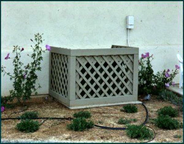 an outdoor planter in front of a white wall