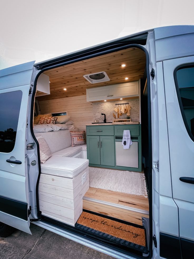 a white van with its door open showing the kitchen and living room area inside it