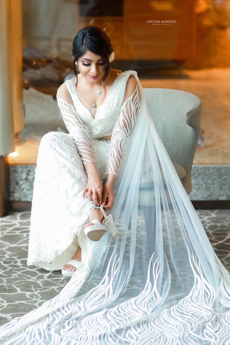 a woman sitting on top of a chair wearing a veil