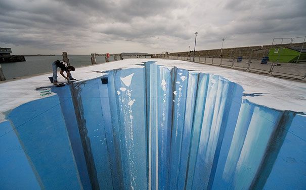 a man is standing on the edge of an upside down pool