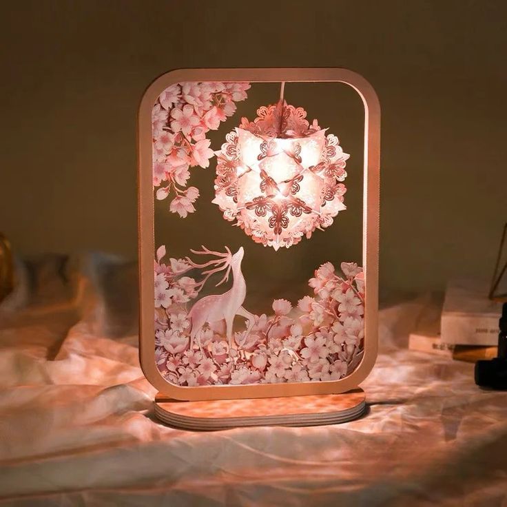 a pink lamp that is on top of a table