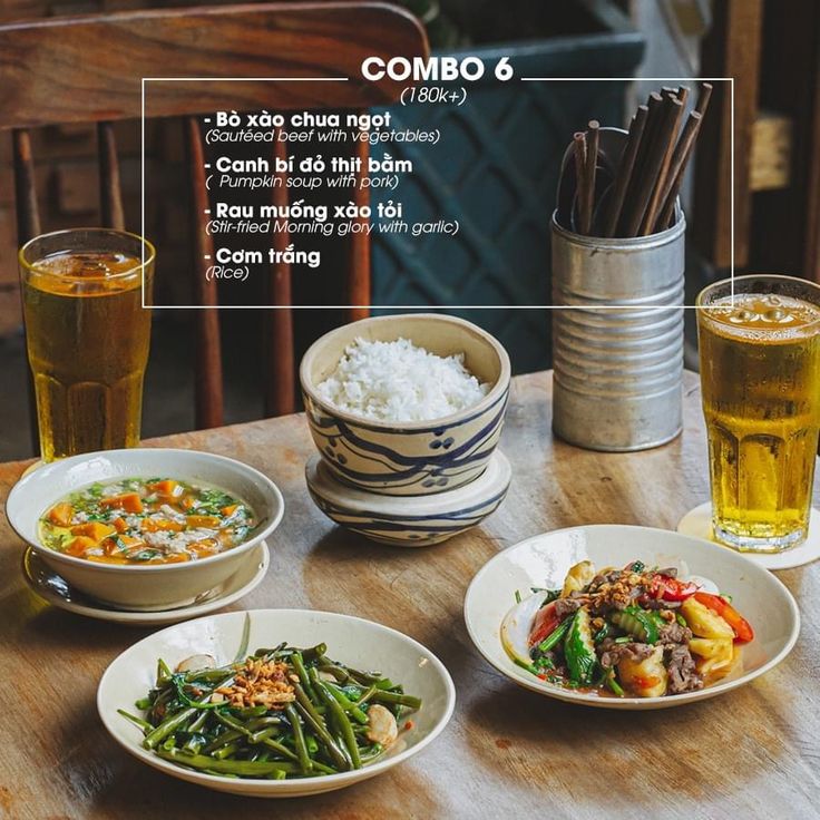 a table with plates and bowls filled with food on top of it next to drinks