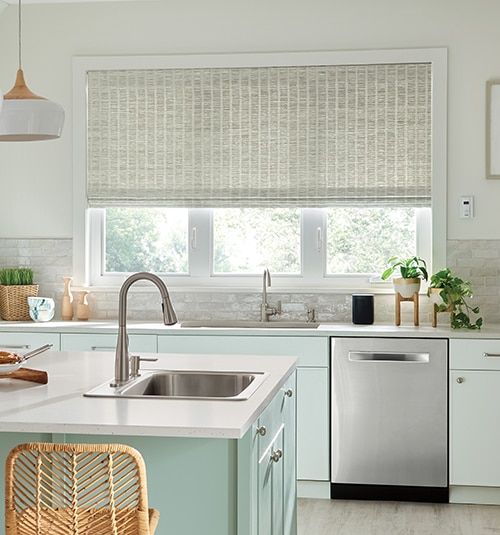 a kitchen with a sink, dishwasher, and window in it's center