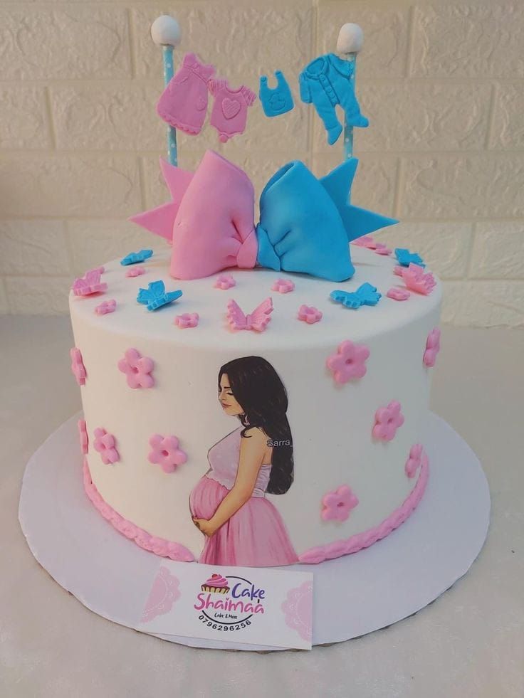 a white cake with pink and blue decorations