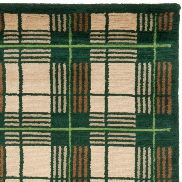 a green and brown rug with squares on it