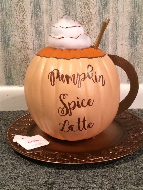 a pumpkin sitting on top of a saucer with the words pumpkin spice latte written on it