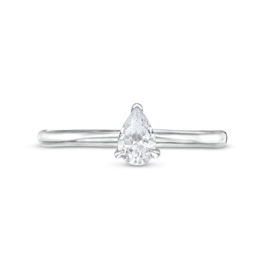 a white gold ring with a pear shaped diamond in the center and a thin band