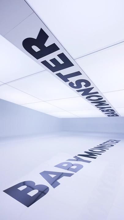 an empty room with black and white letters on the ceiling