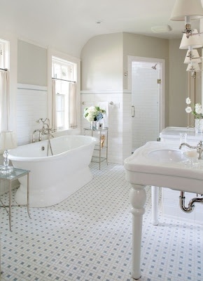 a large bathroom with two sinks and a bathtub in it's center area