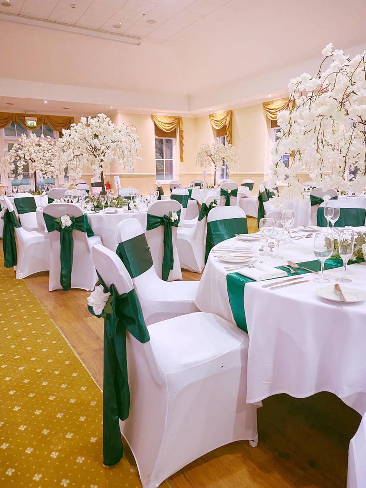 the tables are set with white and green linens