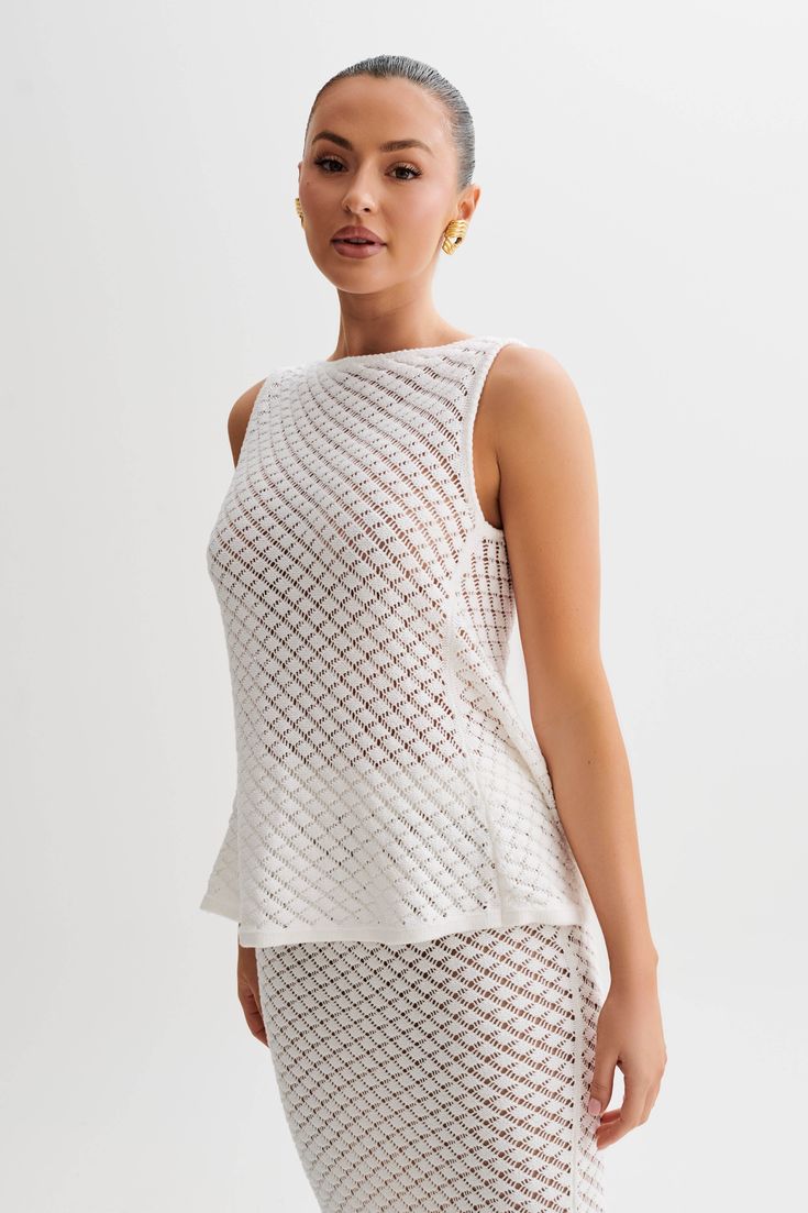 Europe bound.Meet the GUILIANA Sleeveless Knit Top, where sophistication meets modernity in perfect harmony. Its boat neckline frames the shoulders elegantly, exuding timeless charm with a touch of allure. Crafted with meticulous attention to detail, the special knit design adds texture and dimension to your ensemble. Featuring an alluring open back detail and a longline cut for added sophistication, it's a versatile piece that effortlessly transitions from day to night. With a back functional b Elegant Knit Top, Elegant Fine Knit Tank Top, Elegant Summer Knit Top, Elegant Fine Knit Summer Tank Top, Elegant Sleeveless Fine Knit Top, Elegant Sleeveless Pointelle Knit Top, Elegant Pointelle Knit Tank Top, Elegant Sleeveless Textured Knit Top, Elegant Summer Crochet Top