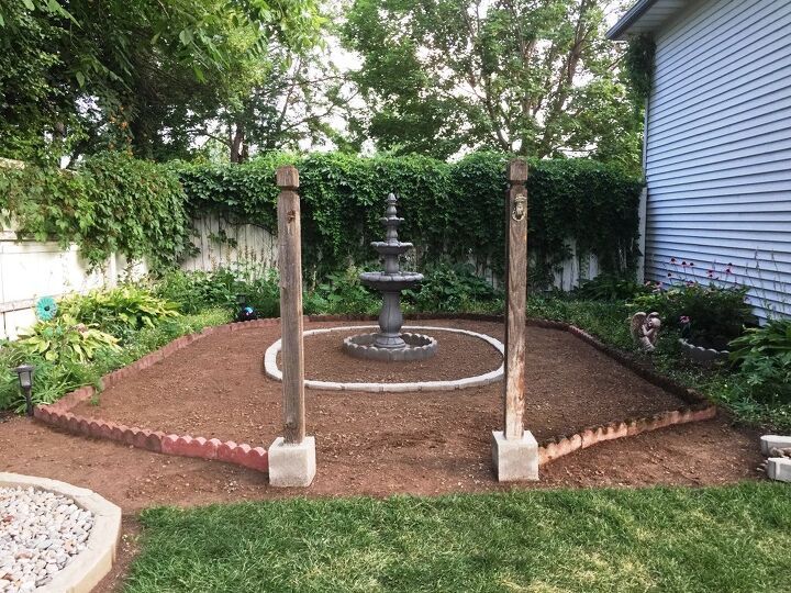 an outdoor fountain in the middle of a garden