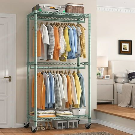 an organized closet with clothes and shoes on wheels in a bedroom or living room area