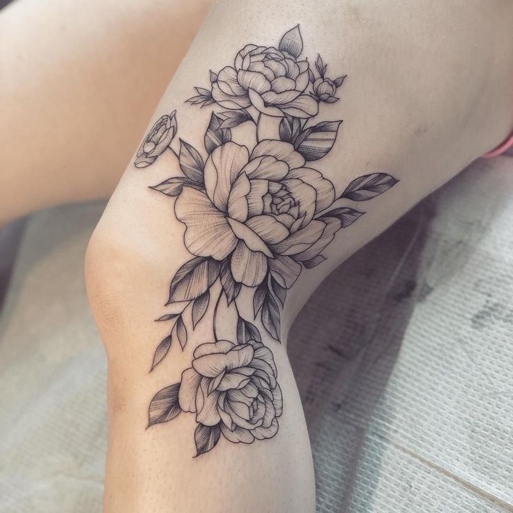 a woman's leg with flowers on it