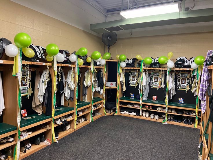 the locker room is decorated with green and white balloons, football jerseys, and other sports memorabilia