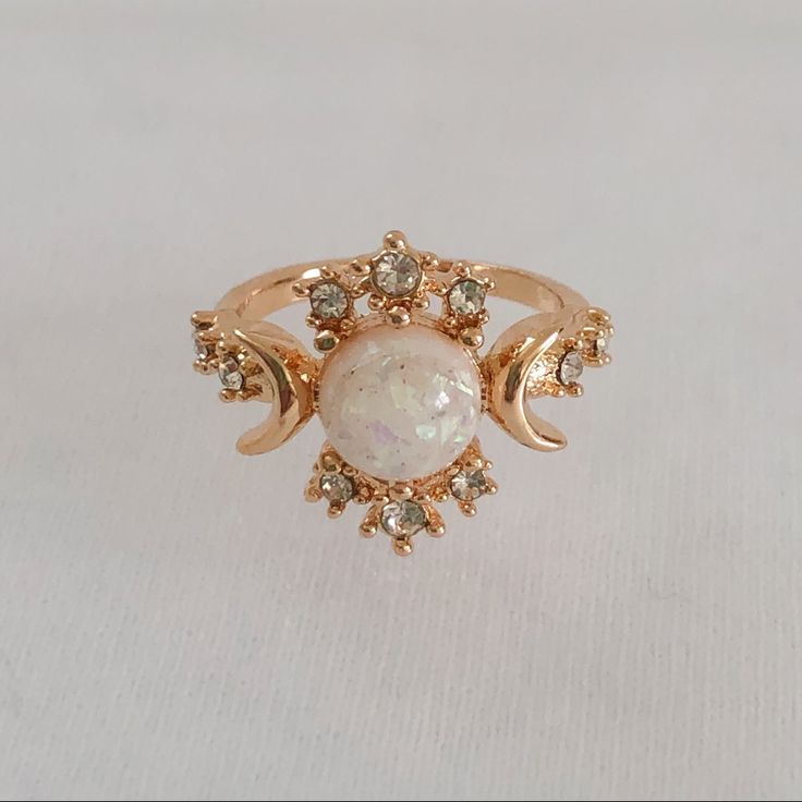 Gold Plated, White Opal (Simulated) Celestial Ring. Features The “Sun”, “Moon”, And “Stars” Represented By The Different Stones. Item Is A Size 6, New, And Unworn. Please Ask Me Any Questions You May Have Prior To Making A Purchase. Engagement Rings Sun, Gold Sun Ring, Opal And Pearl Engagement Ring, Sun And Moon Wedding Rings, Adjustable White Celestial Rings, Adjustable White Jewelry With Sun And Moon Design, Adjustable White Sun And Moon Jewelry, Sun And Moon Themed Wedding, Star Engagement Ring