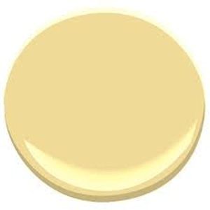 a yellow paint color with white trim on the top and bottom, it's light beige