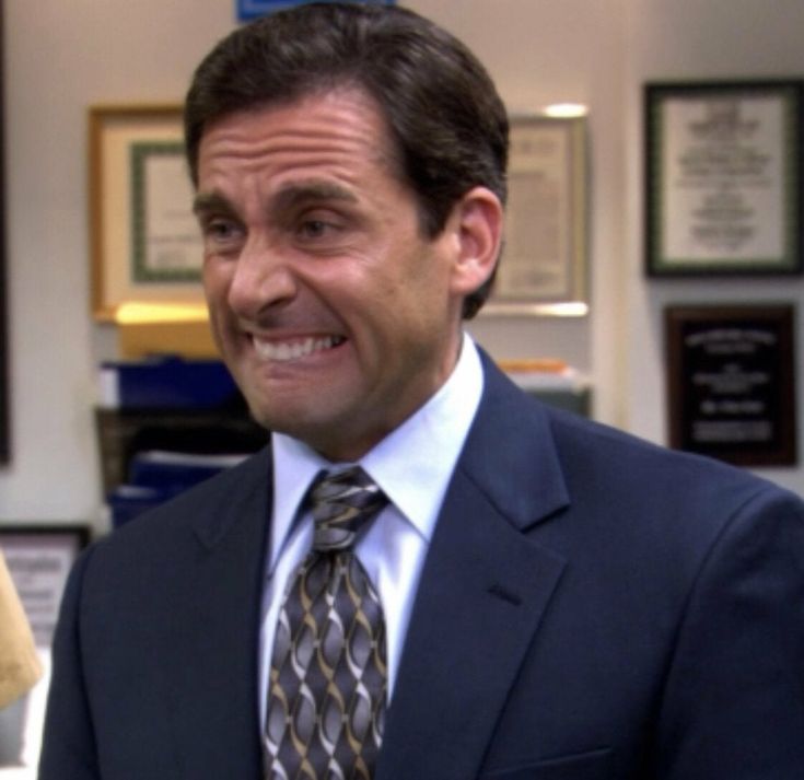 a man wearing a suit and tie in an office