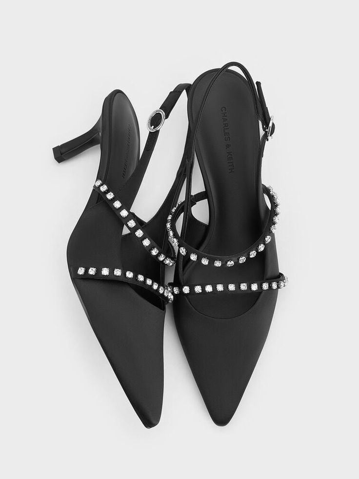 These black Mary Jane pumps exude a vintage vibe, thanks to their pretty satin finish and classically feminine design. Featuring two sparkling crystal-embellished straps across each vamp, they sit on mid-height stiletto heels that will give you a boost in both confidence and stature. The elasticised slingback straps ensure these shoes are easy to put on and take off -- they can also be adjusted for a comfortable and secure fit. Mary Jane Pumps, Charles Keith, Vintage Vibe, Feminine Design, Black Textures, Sparkling Crystal, Vintage Vibes, Satin Finish, Put On