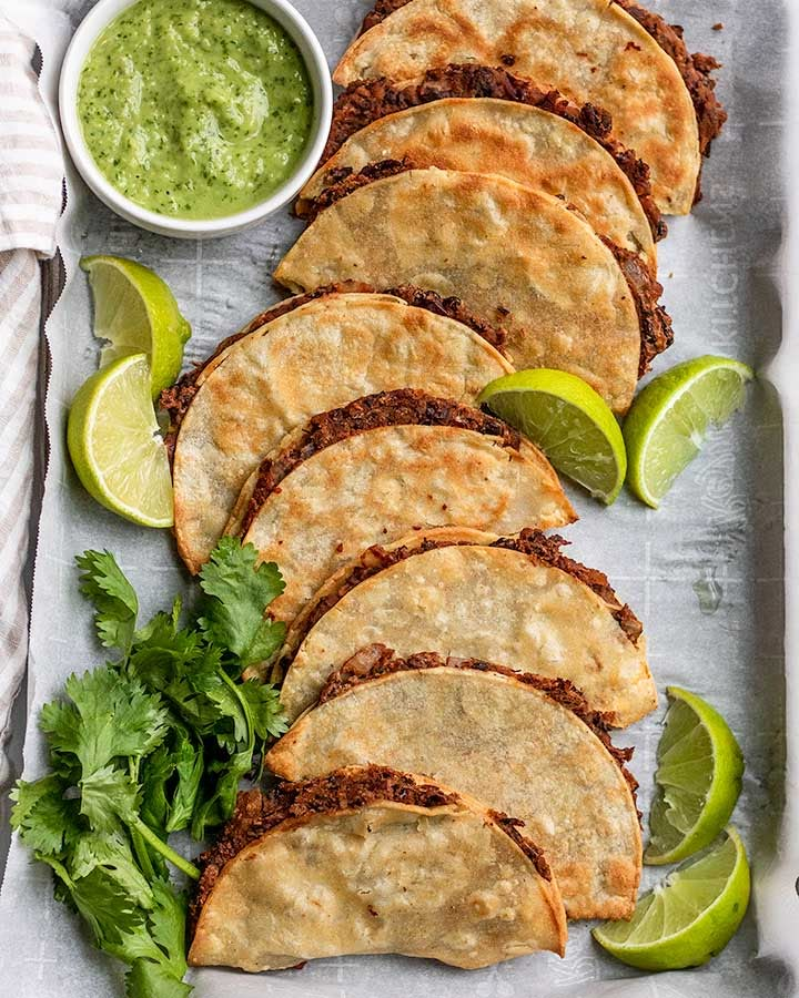 crispy black bean tacos with guacamole and cilantro sauce