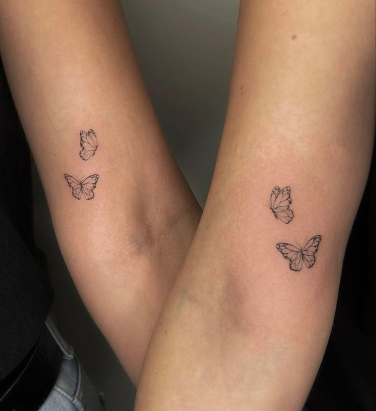 two people with tattoos on their legs and one has a butterfly tattoo on her arm