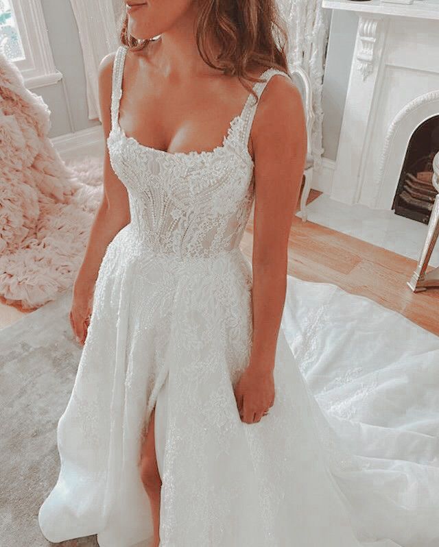 a woman in a white wedding dress sitting on the floor