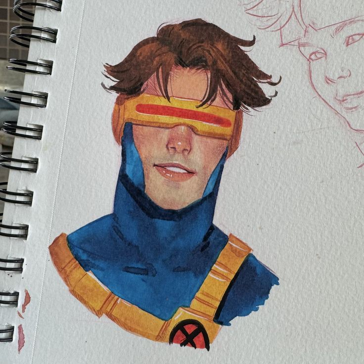 a drawing of a man wearing a blue suit and yellow mask on top of a notebook